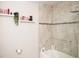 Bright bathroom with modern tile shower and floating shelves for stylish storage at 5963 Glory Bower Dr, Winter Garden, FL 34787