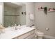 Tidy bathroom featuring a shower, large mirror, and open shelving at 5963 Glory Bower Dr, Winter Garden, FL 34787
