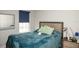 Comfortable bedroom features a window, accent pillows, and a night stand at 5963 Glory Bower Dr, Winter Garden, FL 34787