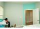 Bedroom with turquoise accent wall and entry door at 5963 Glory Bower Dr, Winter Garden, FL 34787