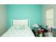 Cozy bedroom with turquoise accent wall and comfortable bed at 5963 Glory Bower Dr, Winter Garden, FL 34787