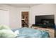 View of the bedroom shows a television, stairway and a plushy blue blanket at 5963 Glory Bower Dr, Winter Garden, FL 34787