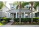 Charming home with well-manicured landscaping and inviting front porch framed by beautiful palm trees at 5963 Glory Bower Dr, Winter Garden, FL 34787