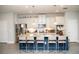 Bright kitchen features white cabinets, granite countertops and a large blue island with seating at 5963 Glory Bower Dr, Winter Garden, FL 34787