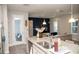 Kitchen island with granite countertop, stainless steel sink, and view of the living room at 5963 Glory Bower Dr, Winter Garden, FL 34787