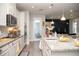 Modern kitchen with granite counters, stainless appliances, white cabinets and island seating at 5963 Glory Bower Dr, Winter Garden, FL 34787