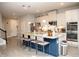 Spacious kitchen has a large granite island, white cabinets, stainless appliances, and an open layout at 5963 Glory Bower Dr, Winter Garden, FL 34787