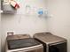 Laundry room features updated machines and storage space at 5963 Glory Bower Dr, Winter Garden, FL 34787