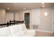 Relaxing upstairs landing area with white sofa and access to the bathroom at 5963 Glory Bower Dr, Winter Garden, FL 34787