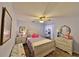Cozy bedroom with light wood furnishings, tile flooring, and a ceiling fan at 604 Timberwilde Ct, Winter Springs, FL 32708