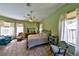 Charming bedroom with tile flooring, natural light, and a decorative wrought iron bed frame at 604 Timberwilde Ct, Winter Springs, FL 32708