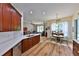 Open-concept kitchen flows into a bright living area with hardwood floors, ideal for Gathering gatherings and relaxation at 604 Timberwilde Ct, Winter Springs, FL 32708