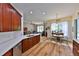 Open-concept kitchen flows into a bright living area with hardwood floors, ideal for Gathering gatherings and relaxation at 604 Timberwilde Ct, Winter Springs, FL 32708
