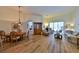 Inviting living room featuring hardwood floors, plenty of seating, and a dining room with natural light at 604 Timberwilde Ct, Winter Springs, FL 32708