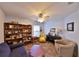 Cozy living room featuring a piano, bookshelves, and comfortable seating arrangements at 604 Timberwilde Ct, Winter Springs, FL 32708