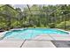 Inviting screened-in pool area with a hot tub, surrounded by lush landscaping and providing a private backyard oasis at 604 Timberwilde Ct, Winter Springs, FL 32708