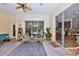 Cozy covered patio with outdoor seating, providing a relaxing space with views of the pool and the interior at 604 Timberwilde Ct, Winter Springs, FL 32708