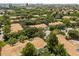 Aerial view of a residential neighborhood with lush green trees and views of city buildings on the horizon at 6874 Slaven Dr, Orlando, FL 32819