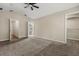 The bedroom is spacious with an open bathroom and closet, neutral carpet, and light paint at 6874 Slaven Dr, Orlando, FL 32819