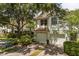 Charming two-story home featuring a two-car garage and lush landscaping, creating an inviting curb appeal at 6874 Slaven Dr, Orlando, FL 32819
