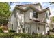 Corner view of a two-story home showing the architectural details and manicured landscaping at 6874 Slaven Dr, Orlando, FL 32819