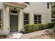 Charming front entrance with neatly trimmed hedges and brick walkway at 6874 Slaven Dr, Orlando, FL 32819