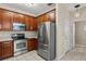 Well-equipped kitchen featuring stainless steel appliances, ample cabinet space, and modern lighting at 6874 Slaven Dr, Orlando, FL 32819