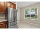 Kitchen with stainless steel refrigerator and a view of the window and counter space at 6874 Slaven Dr, Orlando, FL 32819