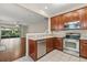 Modern kitchen featuring stainless steel appliances and light countertops at 6874 Slaven Dr, Orlando, FL 32819