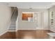 Open-concept living area with view of kitchen and staircase at 6874 Slaven Dr, Orlando, FL 32819