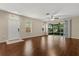 Open living room with hardwood flooring featuring a ceiling fan and natural light at 6874 Slaven Dr, Orlando, FL 32819