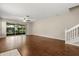 Spacious living room with hardwood floors and sliding glass doors, leading to the lanai at 6874 Slaven Dr, Orlando, FL 32819