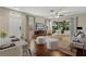 Bright living room with hardwood floors, modern furnishings, and sliding glass doors to the lanai at 6874 Slaven Dr, Orlando, FL 32819