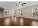 Open-concept living room with hardwood floors, offering a view of the front entrance and kitchen at 6874 Slaven Dr, Orlando, FL 32819