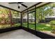 A screened-in porch with a ceiling fan provides a relaxing outdoor living space with views of the backyard at 6874 Slaven Dr, Orlando, FL 32819