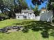 Expansive backyard featuring lush grass and a concrete patio area, perfect for outdoor activities at 714 Springdale Rd, Orlando, FL 32804