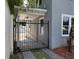 Property featuring a black iron gate with access to a covered porch and home entrance at 714 Springdale Rd, Orlando, FL 32804