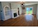 Spacious living room featuring hardwood floors, fireplace, and sliding door access to the backyard at 714 Springdale Rd, Orlando, FL 32804