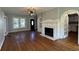 Inviting living room showcasing a fireplace, hardwood floors, and natural light from windows at 714 Springdale Rd, Orlando, FL 32804