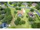 Expansive aerial view of a single-Gathering home with a large yard, pool, and meticulously maintained landscaping at 748 Mills Estate Pl, Chuluota, FL 32766