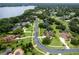 Aerial view of an upscale neighborhood, showcasing a lake, pond, and well-manicured lawns and houses at 748 Mills Estate Pl, Chuluota, FL 32766