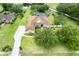 Aerial view of a private home with lush landscaping, screened-in pool, and pond at 748 Mills Estate Pl, Chuluota, FL 32766