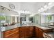 Bathroom featuring multiple sinks and granite countertops, with large mirrors and ample lighting at 748 Mills Estate Pl, Chuluota, FL 32766