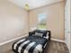 Cozy bedroom with neutral walls, plush carpet, and window letting in natural light at 748 Mills Estate Pl, Chuluota, FL 32766