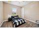 A neutral bedroom featuring a bed, a nightstand, and a window at 748 Mills Estate Pl, Chuluota, FL 32766