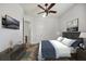 This bedroom features a ceiling fan, TV, painting, and an ensuite bathroom at 748 Mills Estate Pl, Chuluota, FL 32766