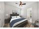 This bedroom features a ceiling fan, a view into the ensuite bathroom, and a large bed at 748 Mills Estate Pl, Chuluota, FL 32766