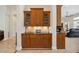 Butler's pantry features wood cabinets, granite counter and an adjoining doorway into the living room at 748 Mills Estate Pl, Chuluota, FL 32766