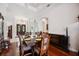 Formal dining room with wood floors, columns, access to the front doors, and views to living room at 748 Mills Estate Pl, Chuluota, FL 32766