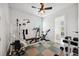 Home exercise room with gym equipment, ceiling fan, and a view into an adjacent room at 748 Mills Estate Pl, Chuluota, FL 32766